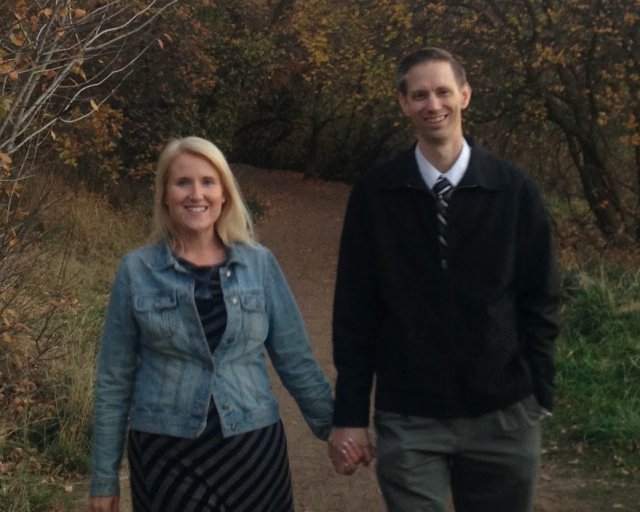 Daniel and Michelle walking together in the woods